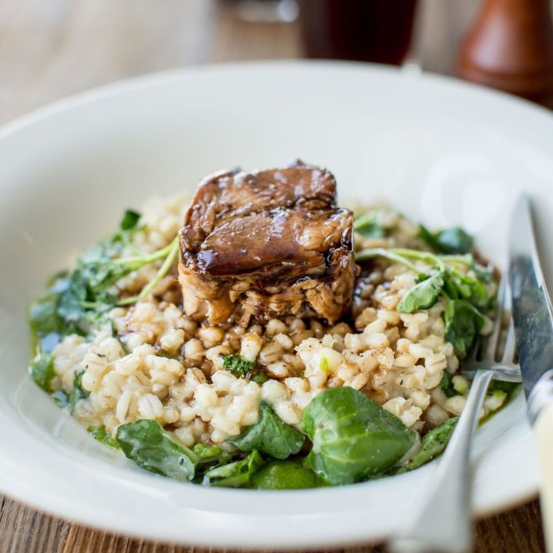Slow-Cooked Hand of Pork with Pearl Barley Risotto, Watercress Pesto and Red Wine Sauce