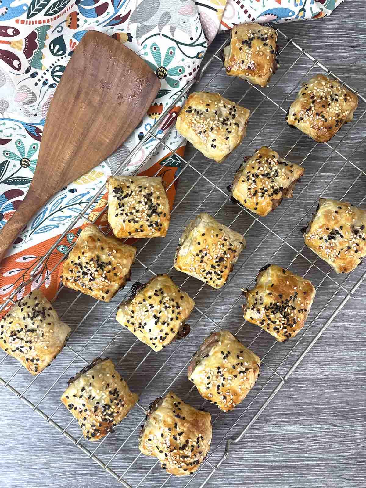 Chicken sausage rolls on a rack.