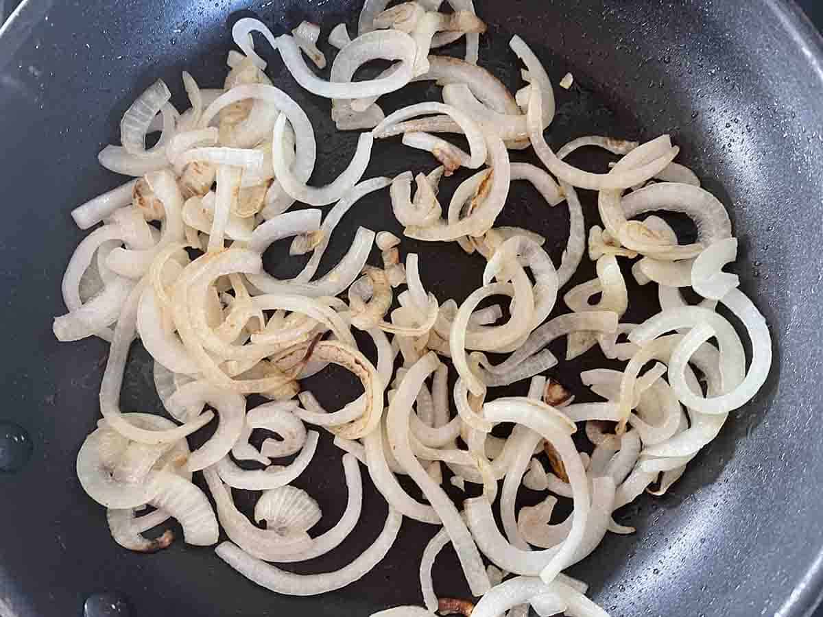 sliced fried onions in a pan.