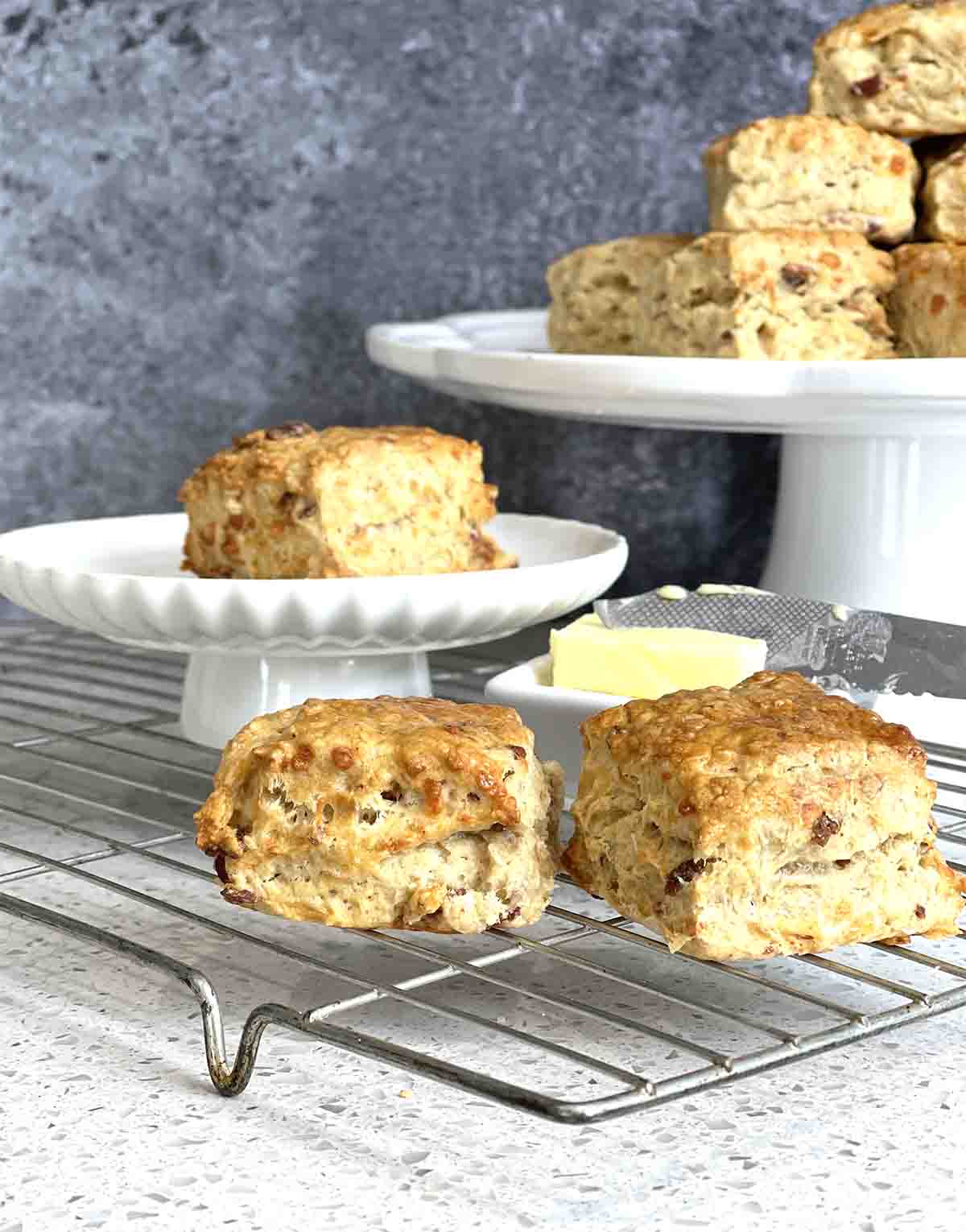 cheese and bacon scones on a rack and some on a stand.