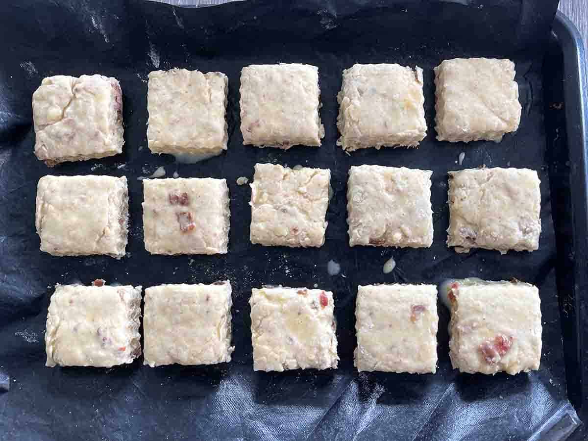 cut square scones ready to cook on a baking sheet.