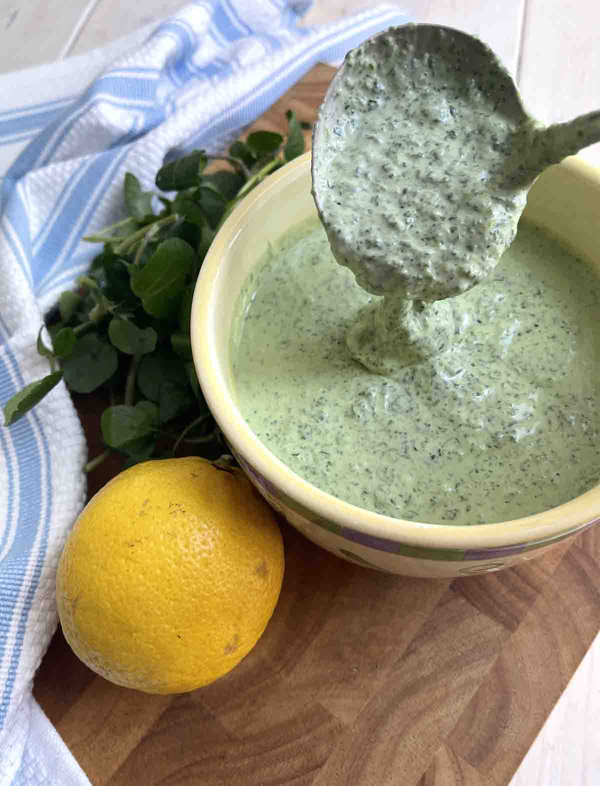 sauce in a bowl with a spoonful of sauce above.