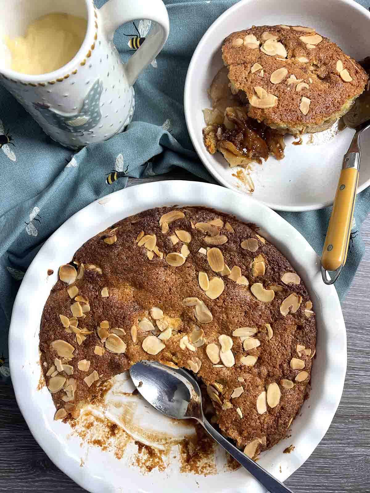 pudding with a portion in a bowl in the background.