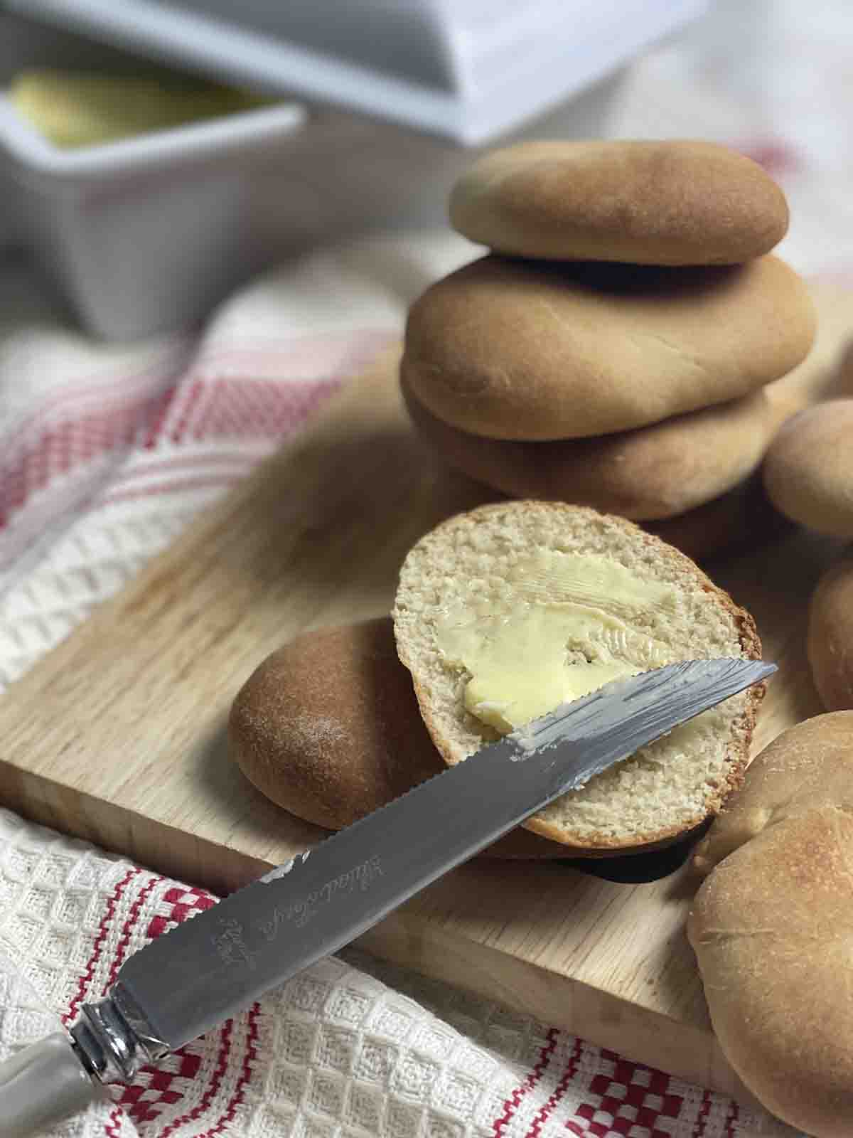 Pile of Kentish huffkins with one split and buttered.
