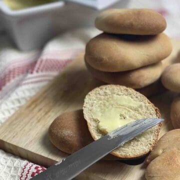 Pile of Kentish huffkins with one split and buttered.