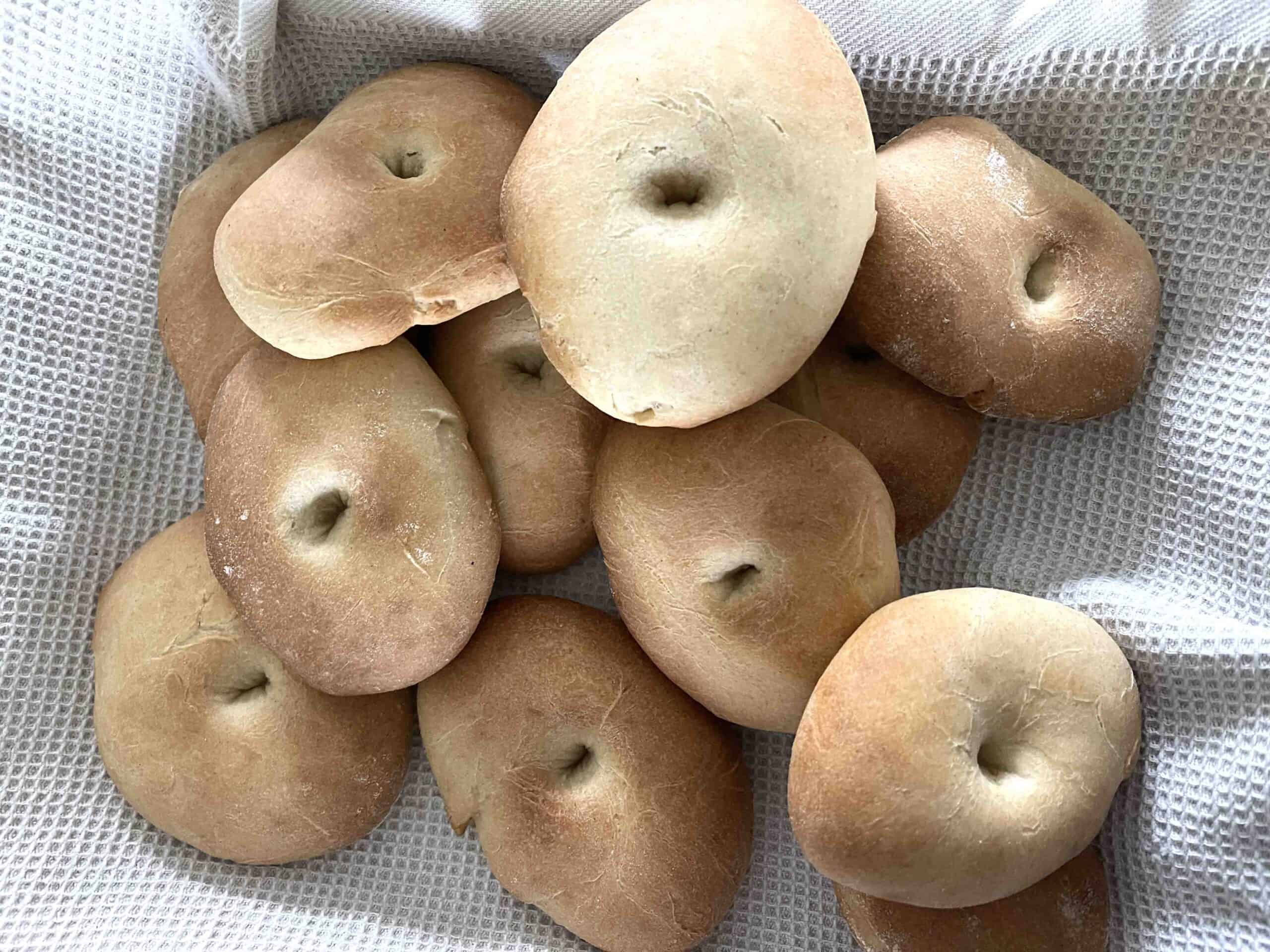 pile of cooked rolls in a teatowel.