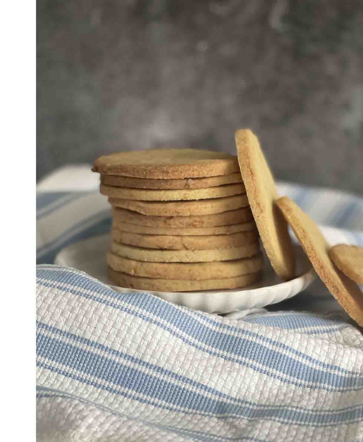 stack of biscuits with some to the side.