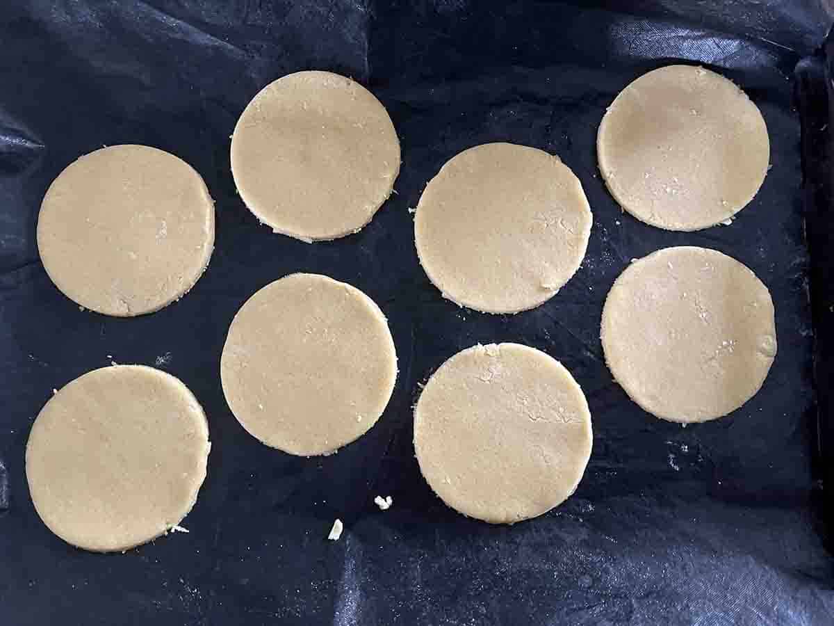 cut out rounds of dough on a baking sheet.