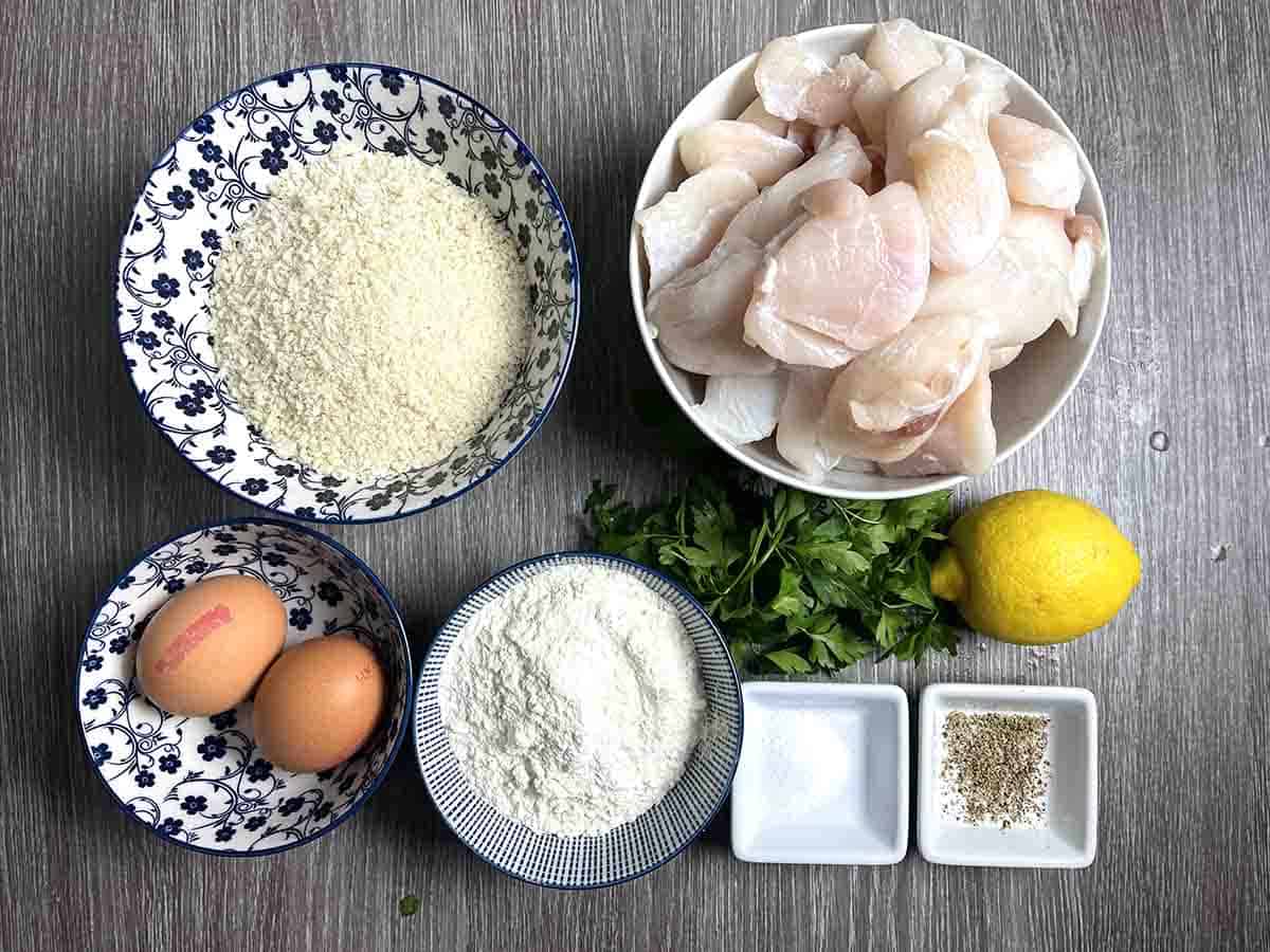ingredients in bowls including, cod cheeks, eggs, panki, flour, lemon and parsley.