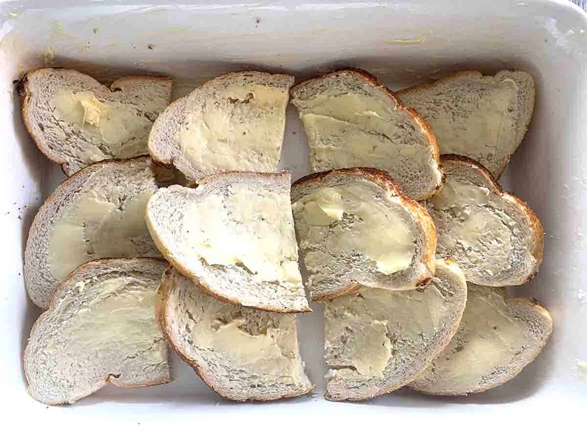 buttered bread in a white dish.