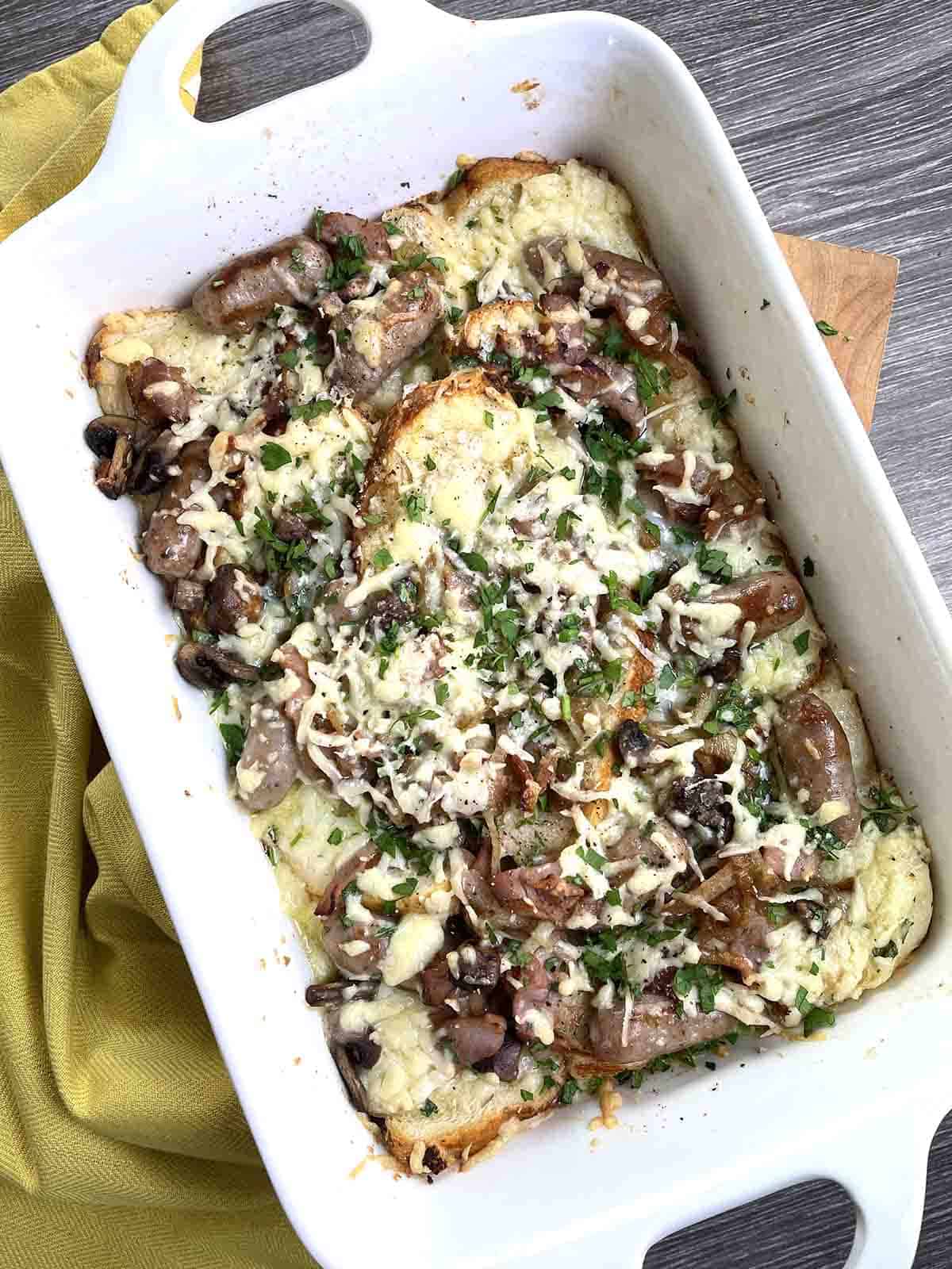 savoury bread and butter pudding in a white dish.