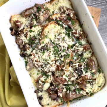 savoury bread and butter pudding in a white dish.