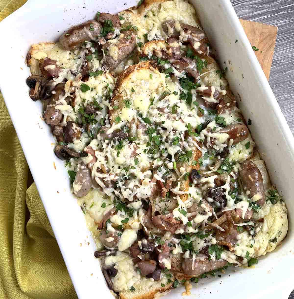 savoury bread and butter pudding in a white dish.