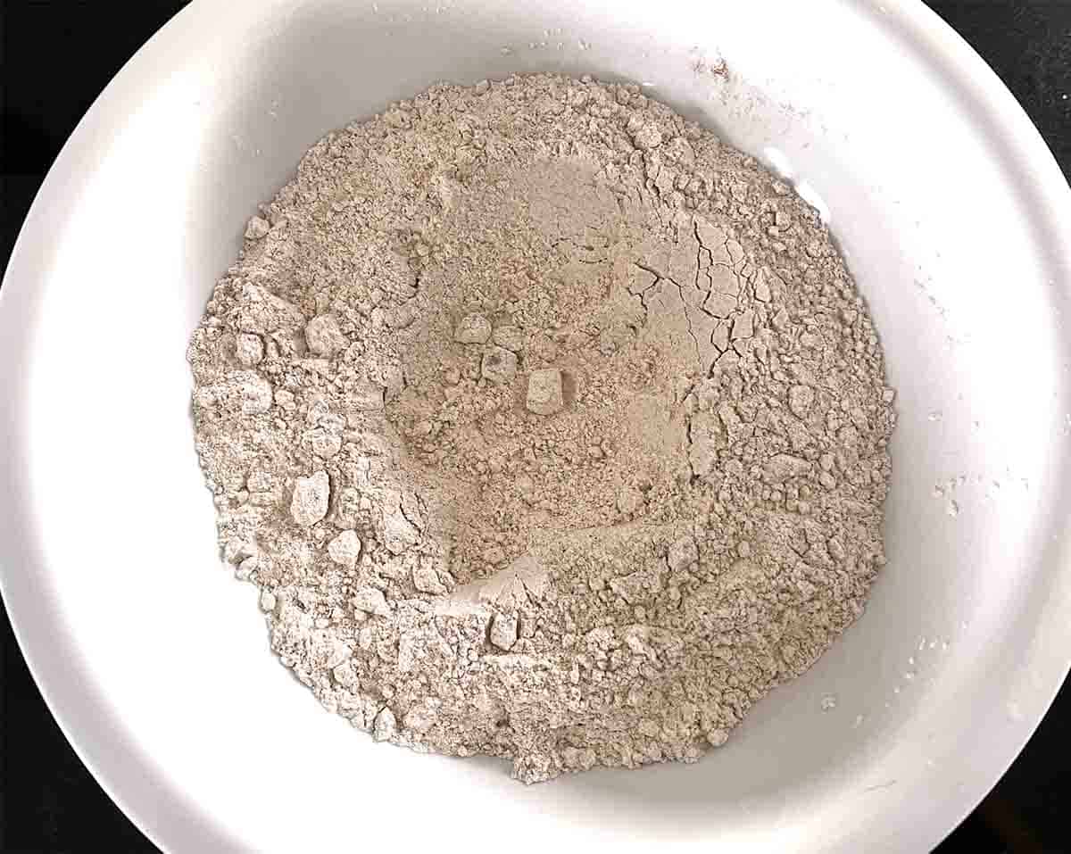 bowl of flour and spices with a well in the middle.
