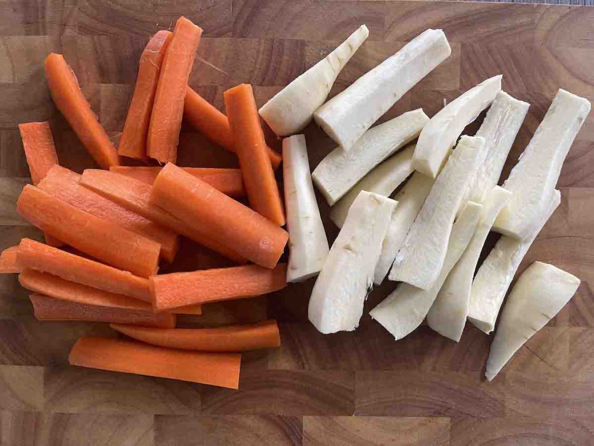cut vegetables on a wooden board.