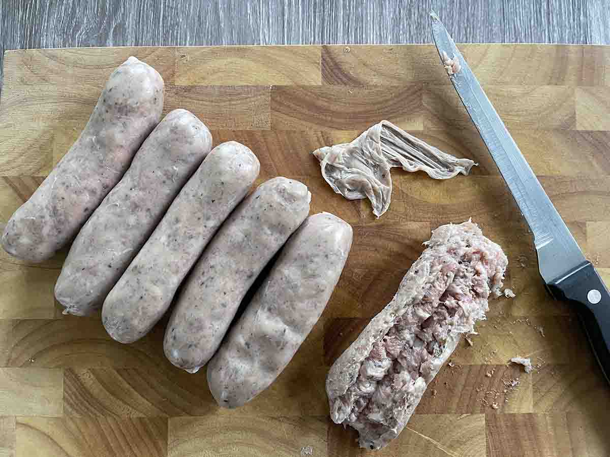 sausages on a board and one split open.