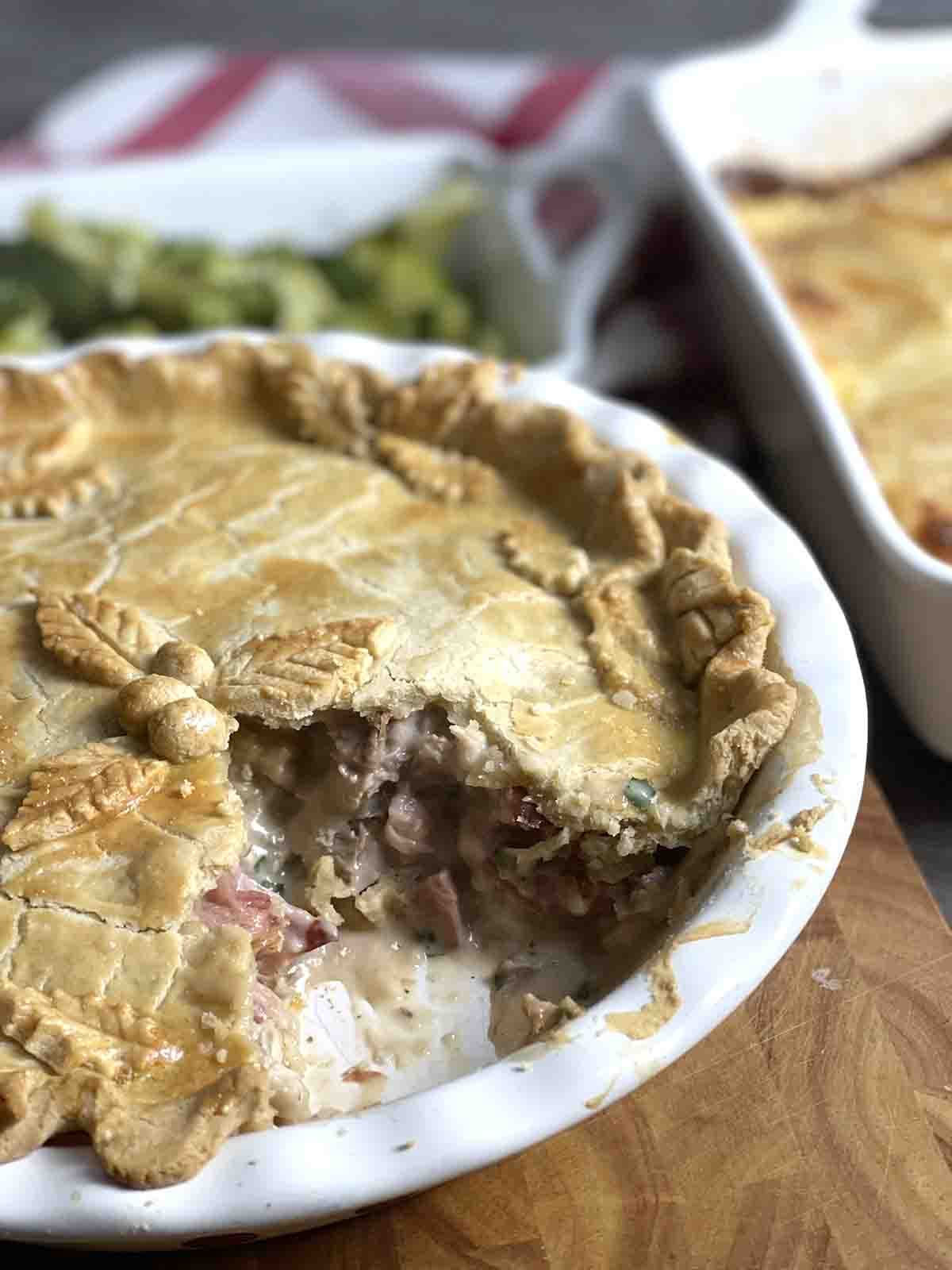 cooked turkey and mushroom pie with a portion removed.