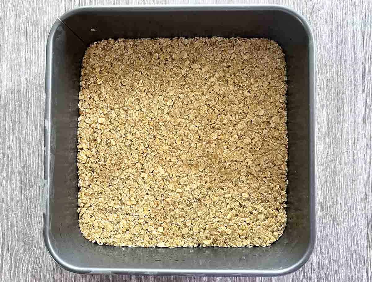 mixture pressed into a square tin before baking.