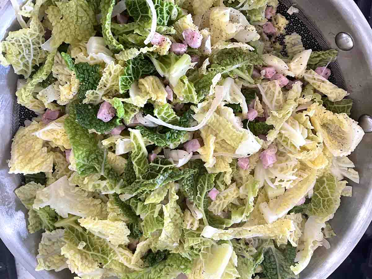 fried cabbage and onion in a frying pan.