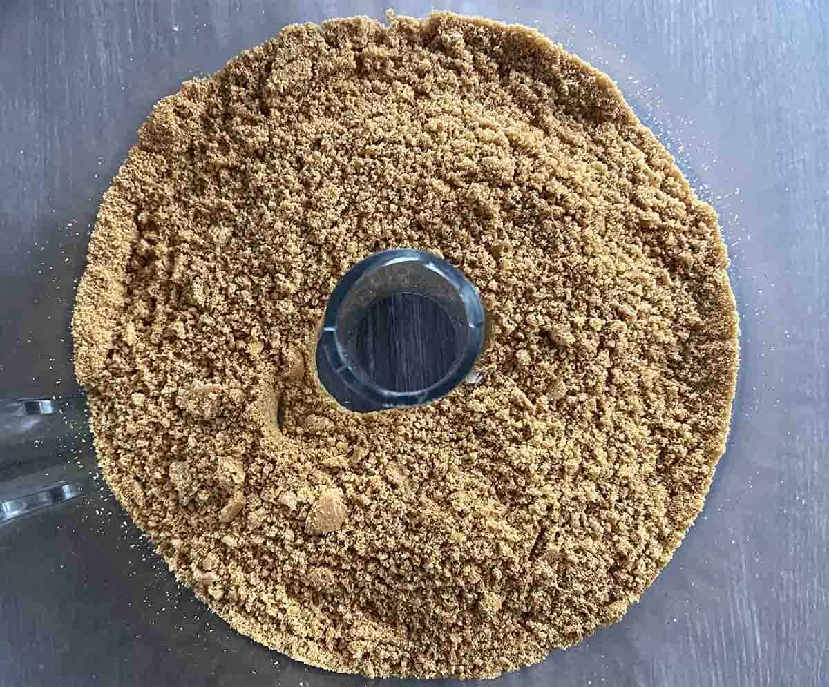 biscuit crumbs in a food processor bowl.
