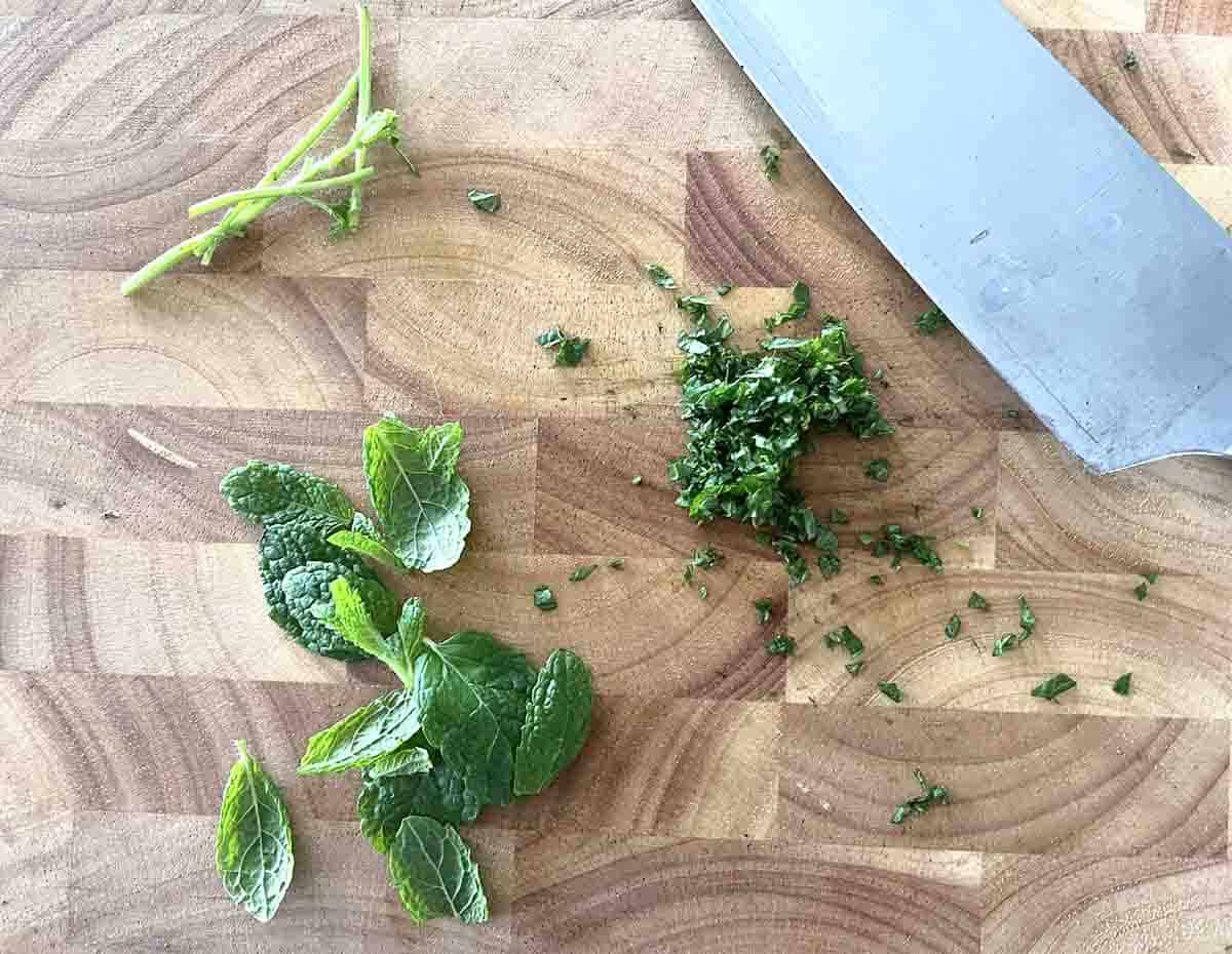 chopped mint on a wooden board.