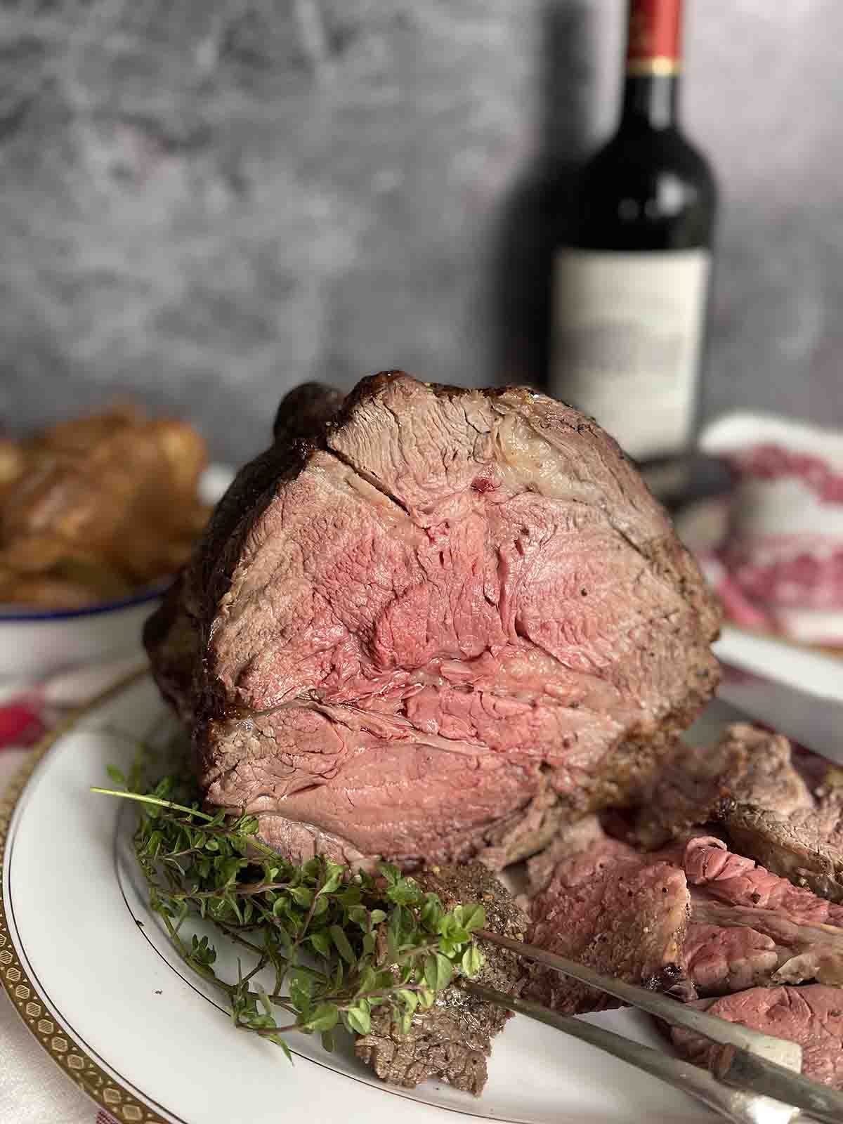 roast rib of beef with slices cut off on a plate.