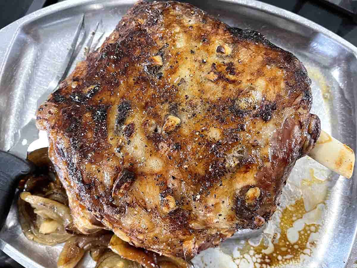 lamb on a carving rack resting.
