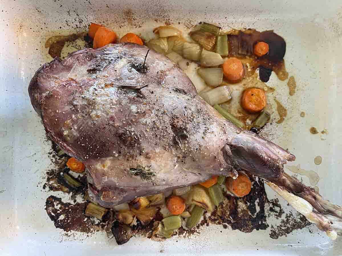 cooked haunch of venison in the roasting dish.