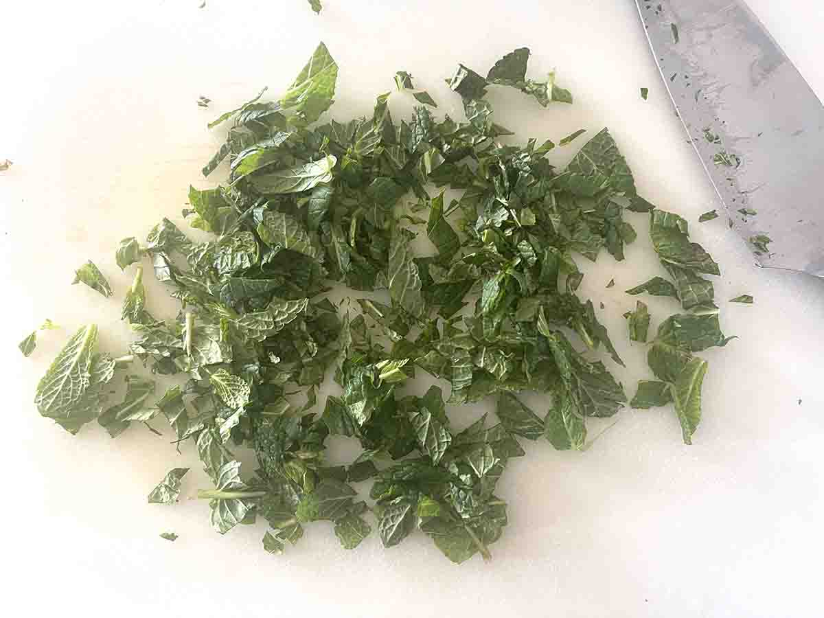 chopped mint on a board.