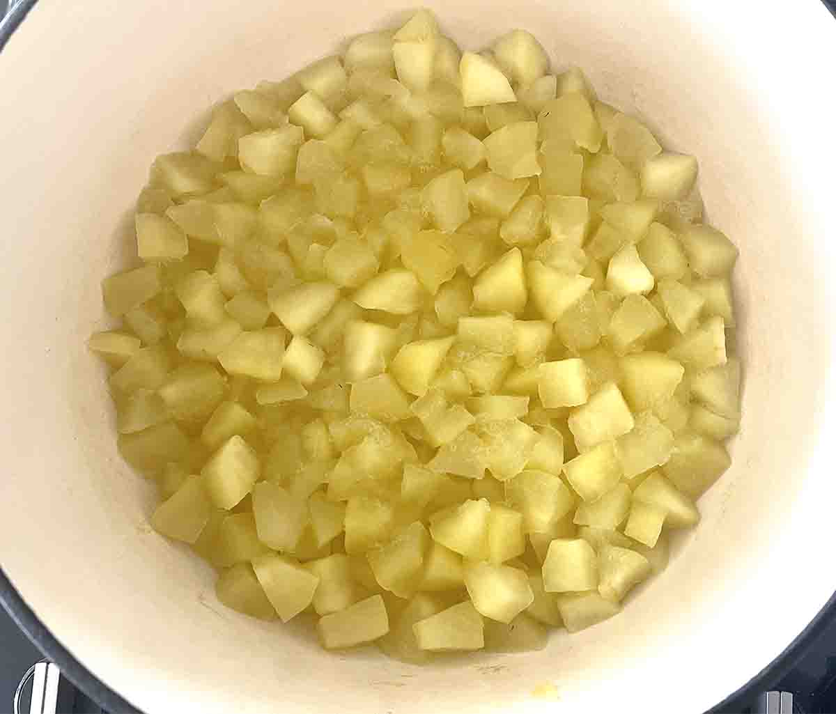cooked apples in a saucepan.