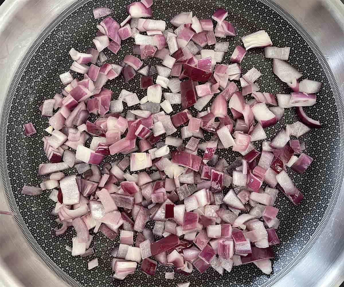 chopped onions cooking in a pan.