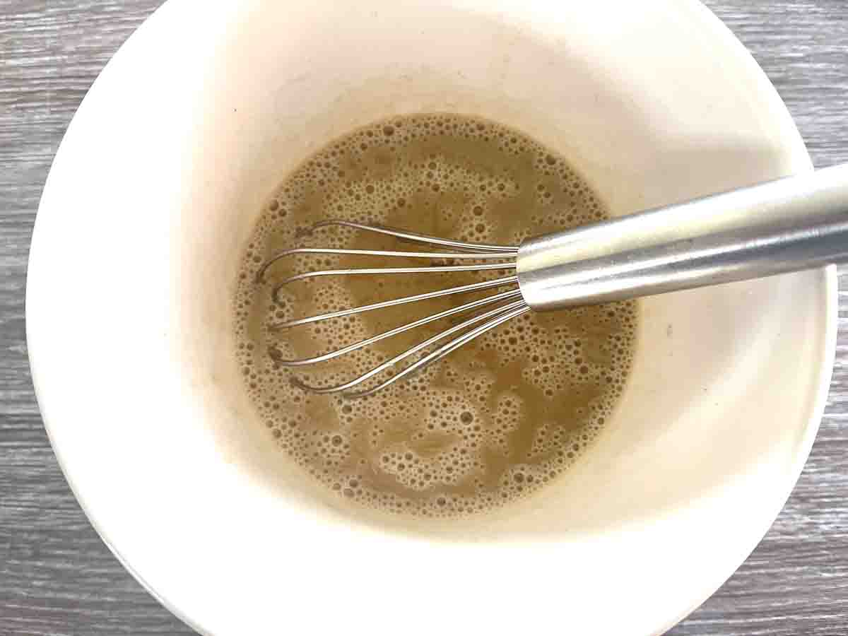 flour, sugar, milk and vanilla whisked into a bowl.