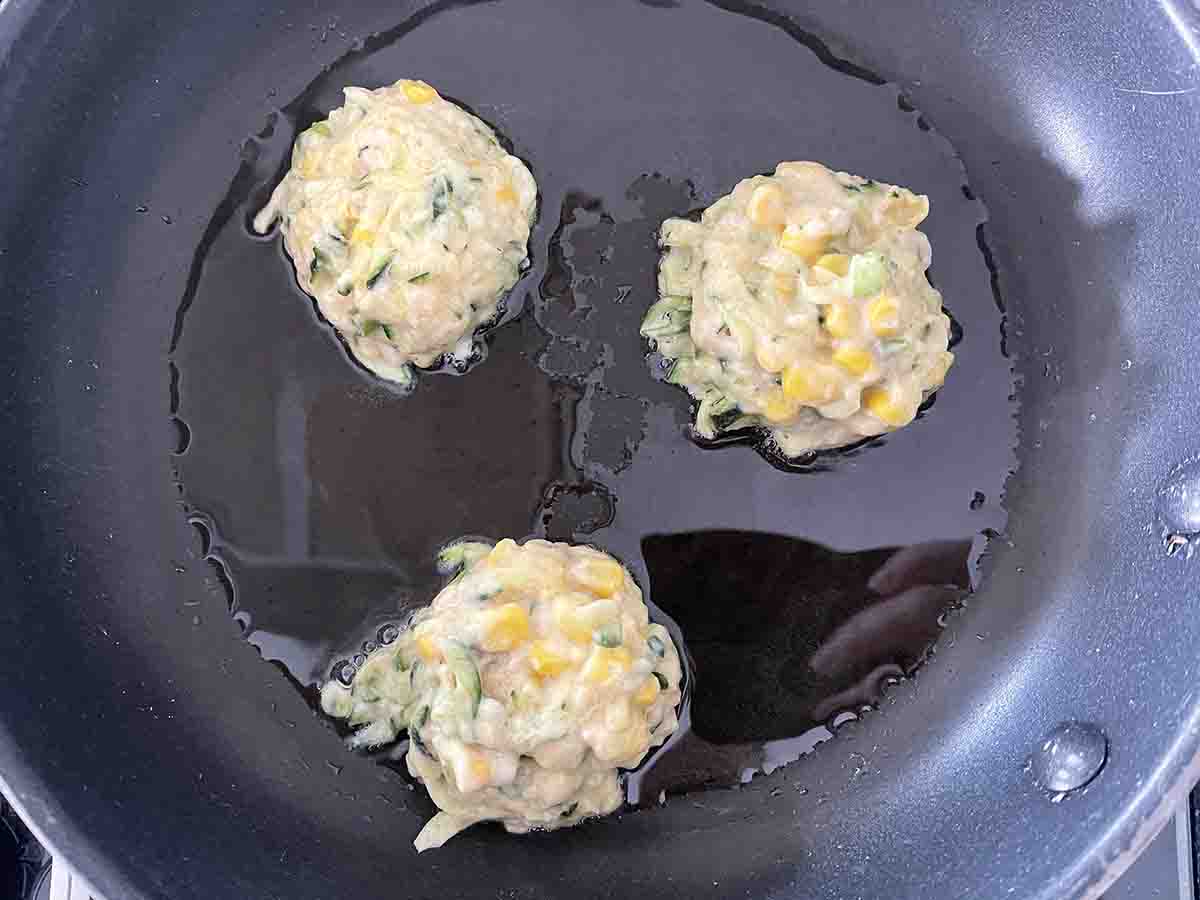 fritters in a frying pan.