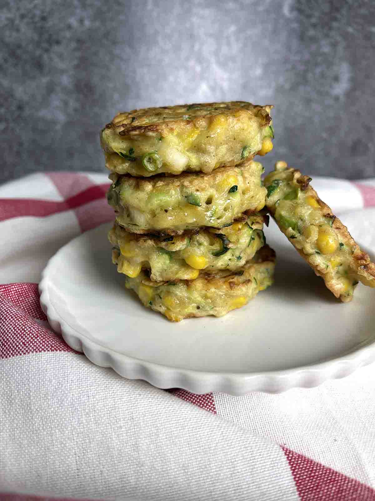 stacked fritters on a plate.
