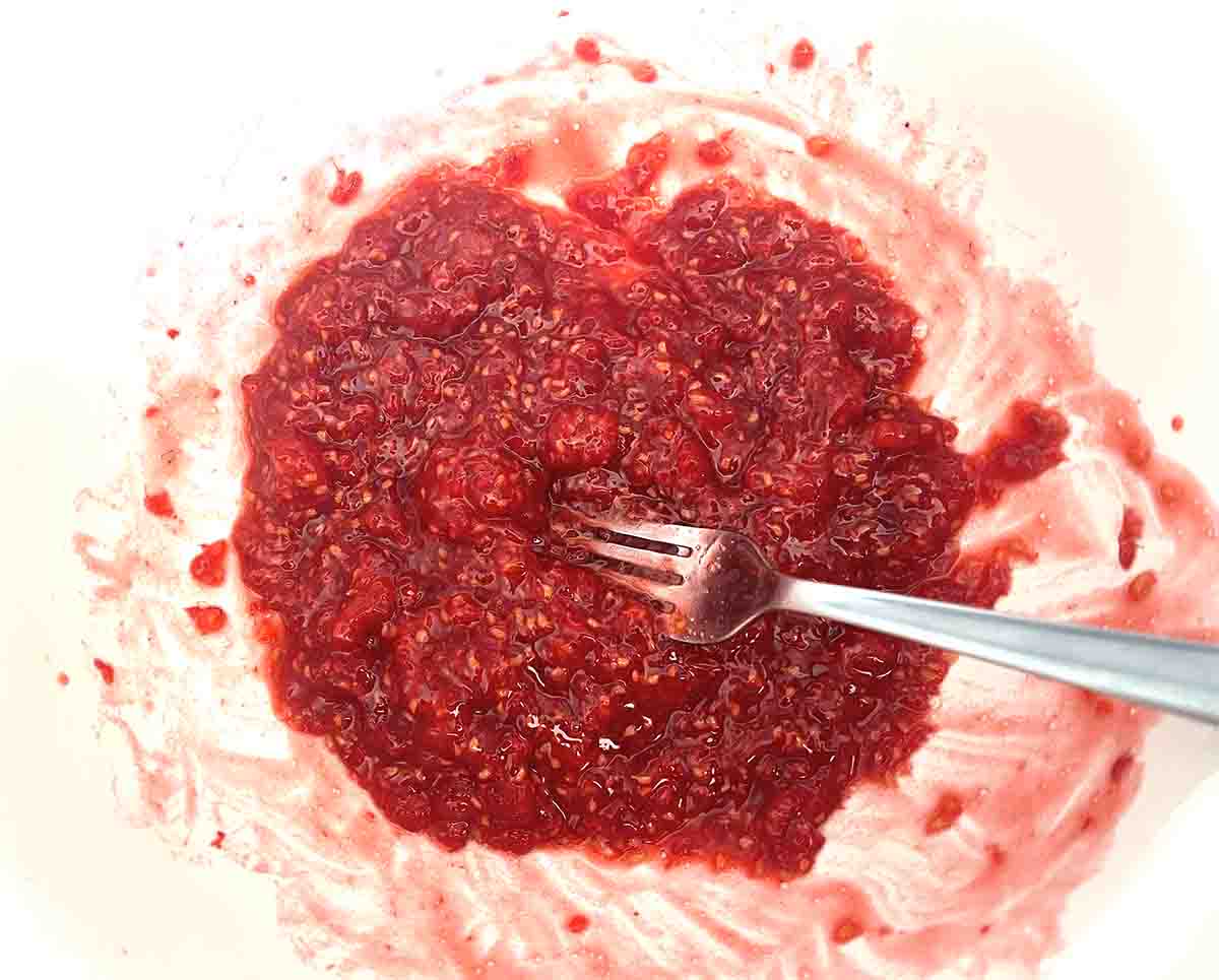 raspberries mashed with a fork.