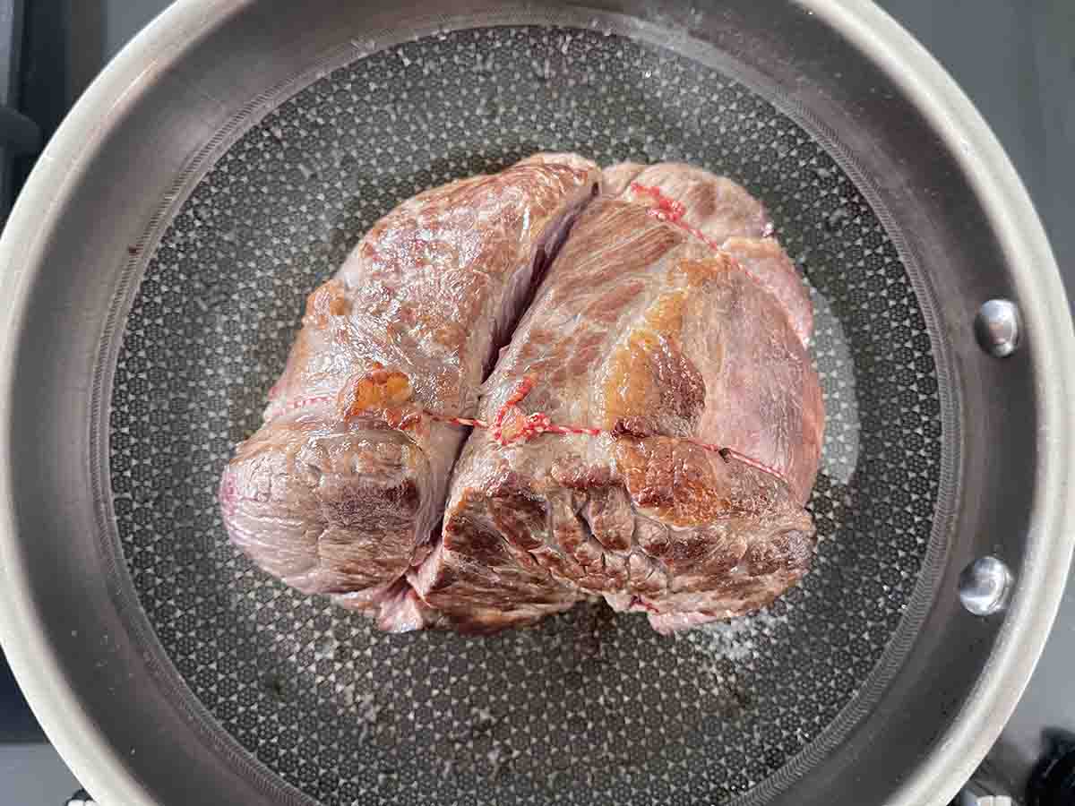beef searing in a pan.