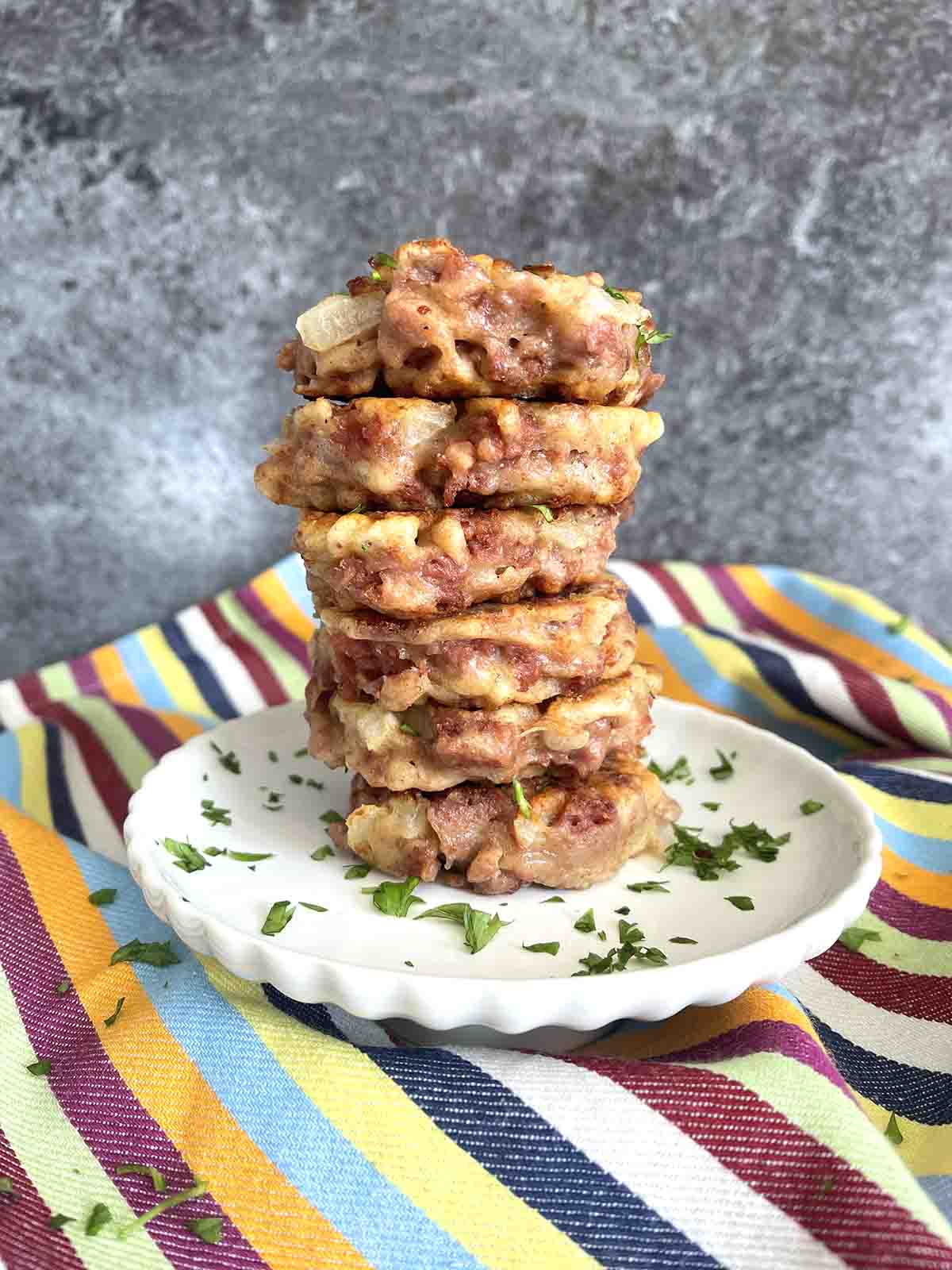 stack of corned beef fritters on a plate.