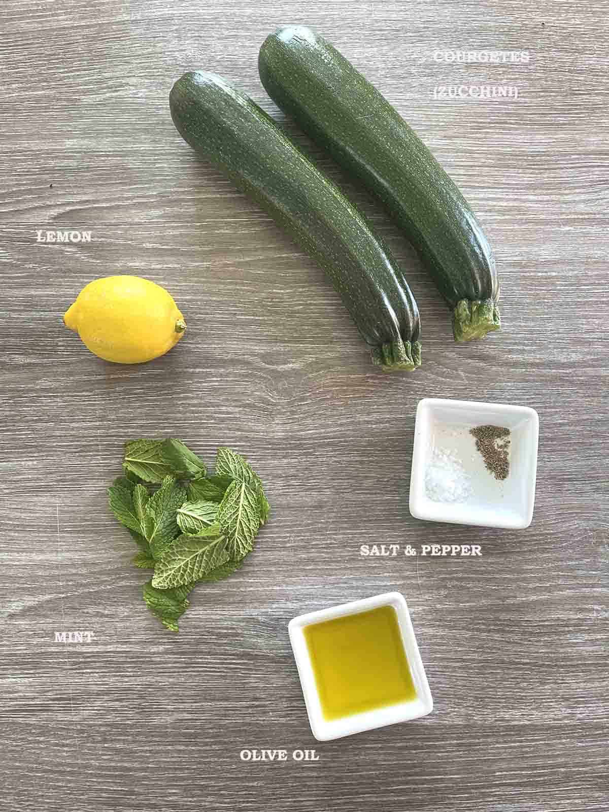 ingrdients including courgettes, mint, lemon, seasoning and olive oil.