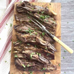 cooked flanken beef short ribs on a board.