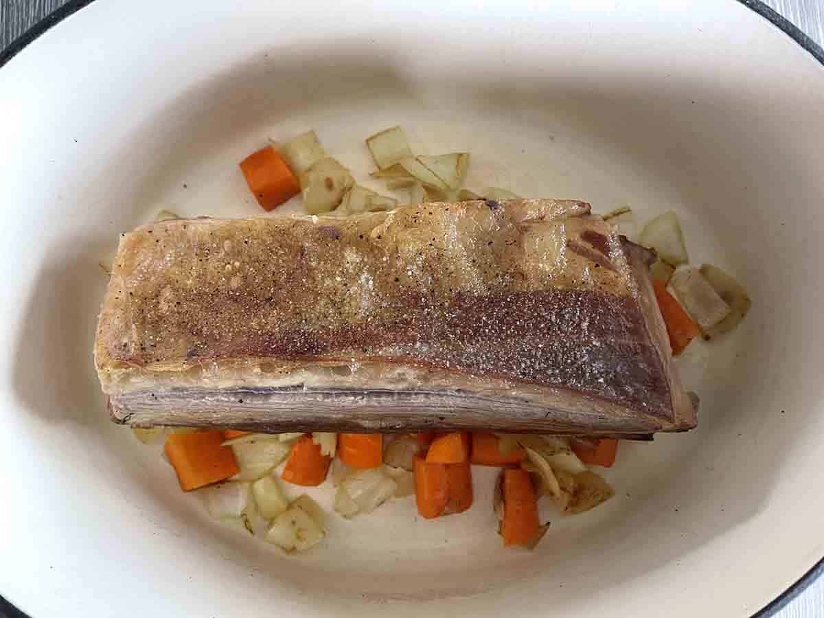 beef on vegetables in a pot.