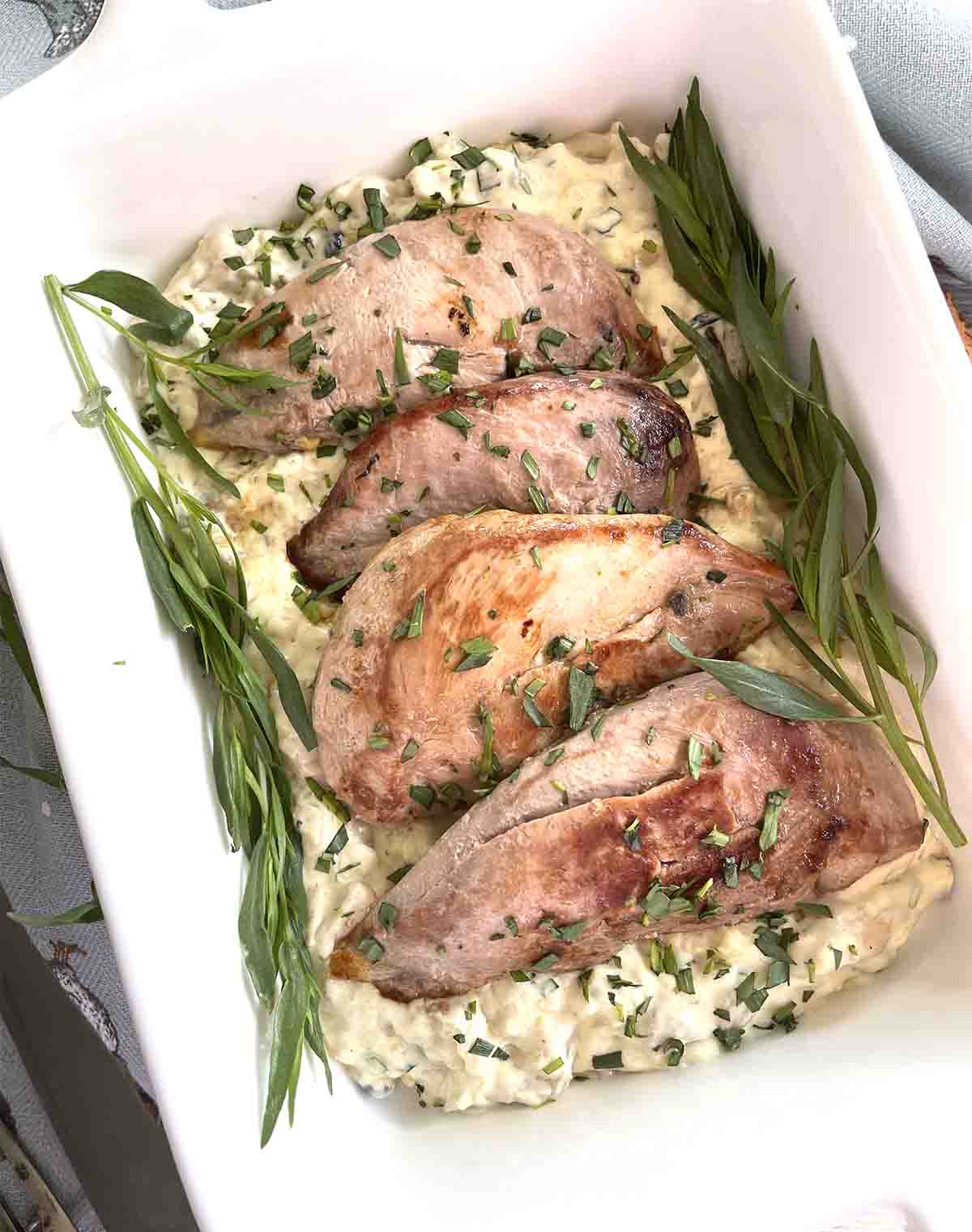 close up of cooked pheasant in sauce.