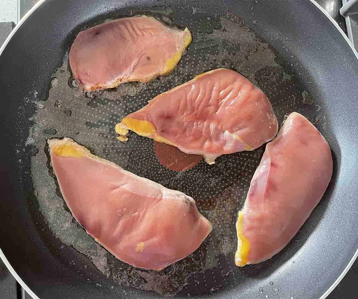 pheasant breast added to a pan.