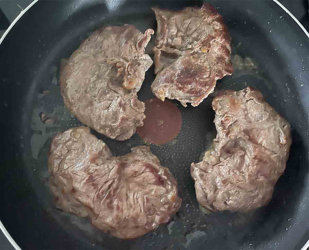 steaks in a pan.
