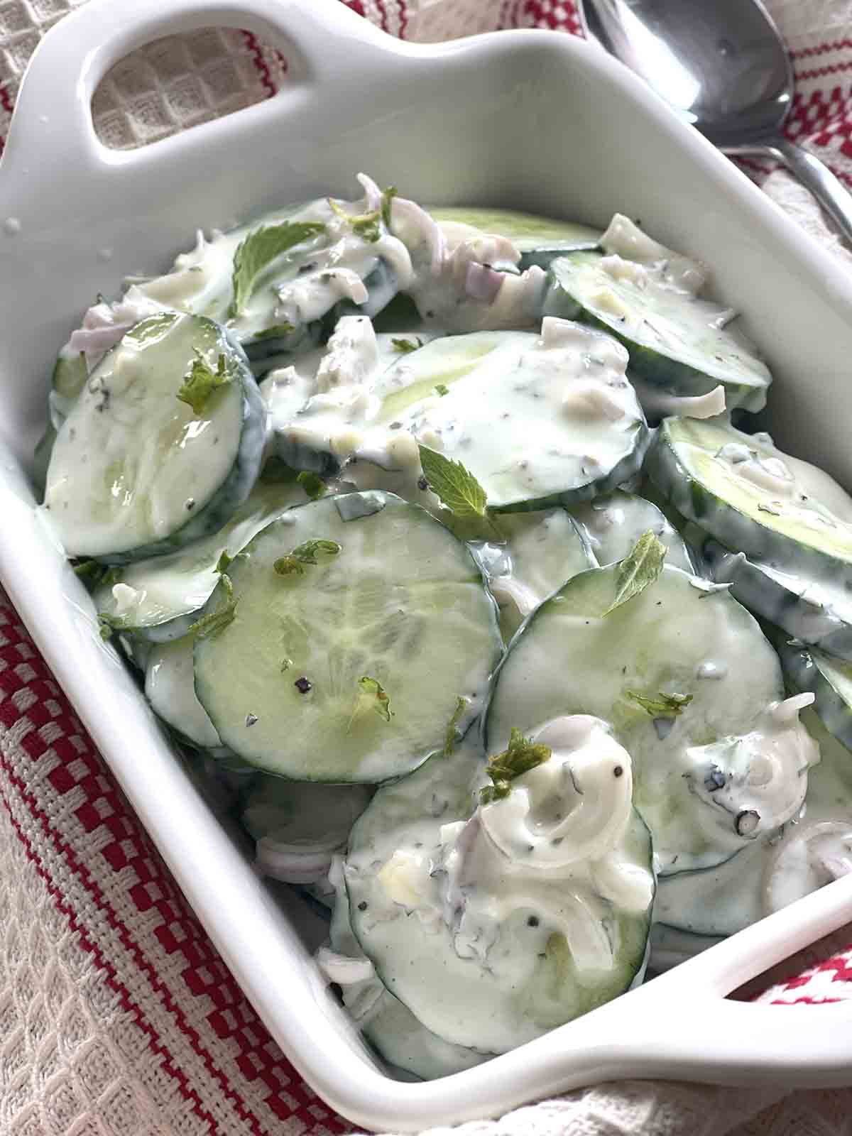 creamy cucumber salad in a dish.