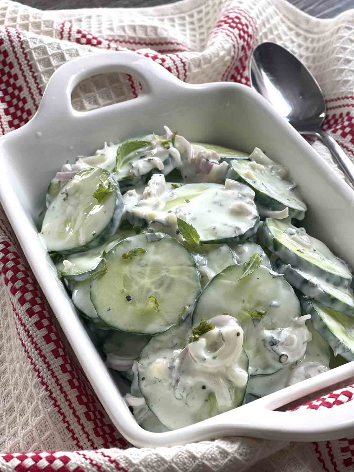 creamy cucumber salad in a dish.