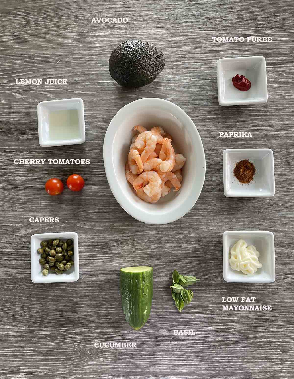 ingredietns including prawns, cucumber, avocado, tomatoes.