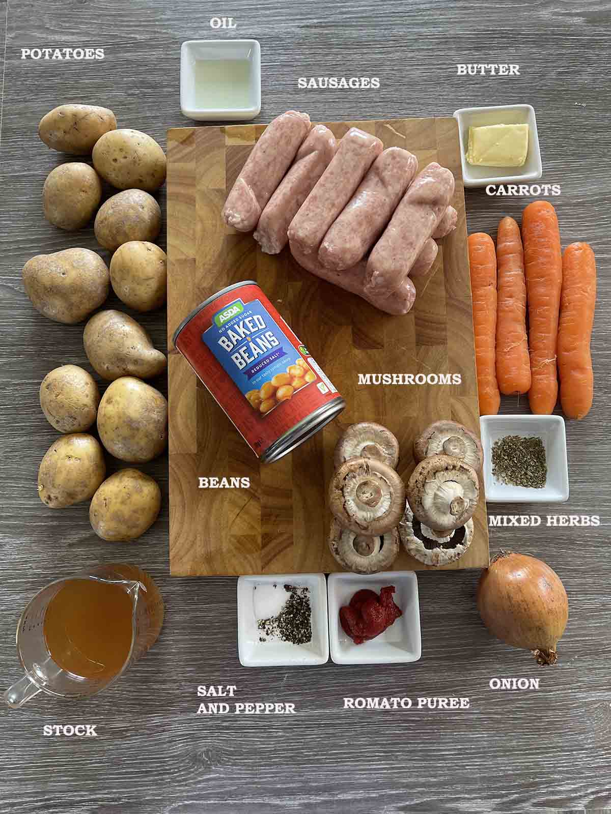 ingredients including sausages, beans, carrots, mushrooms and onions.