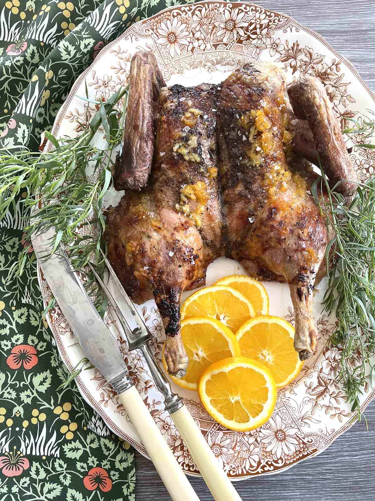 spatchcock duck on a plate .