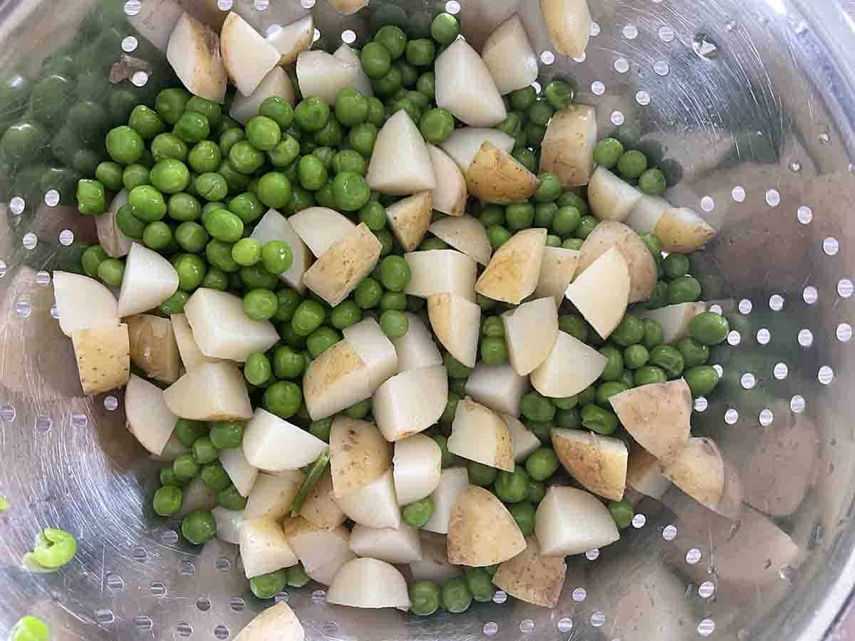 potatoes and peas in a colander
