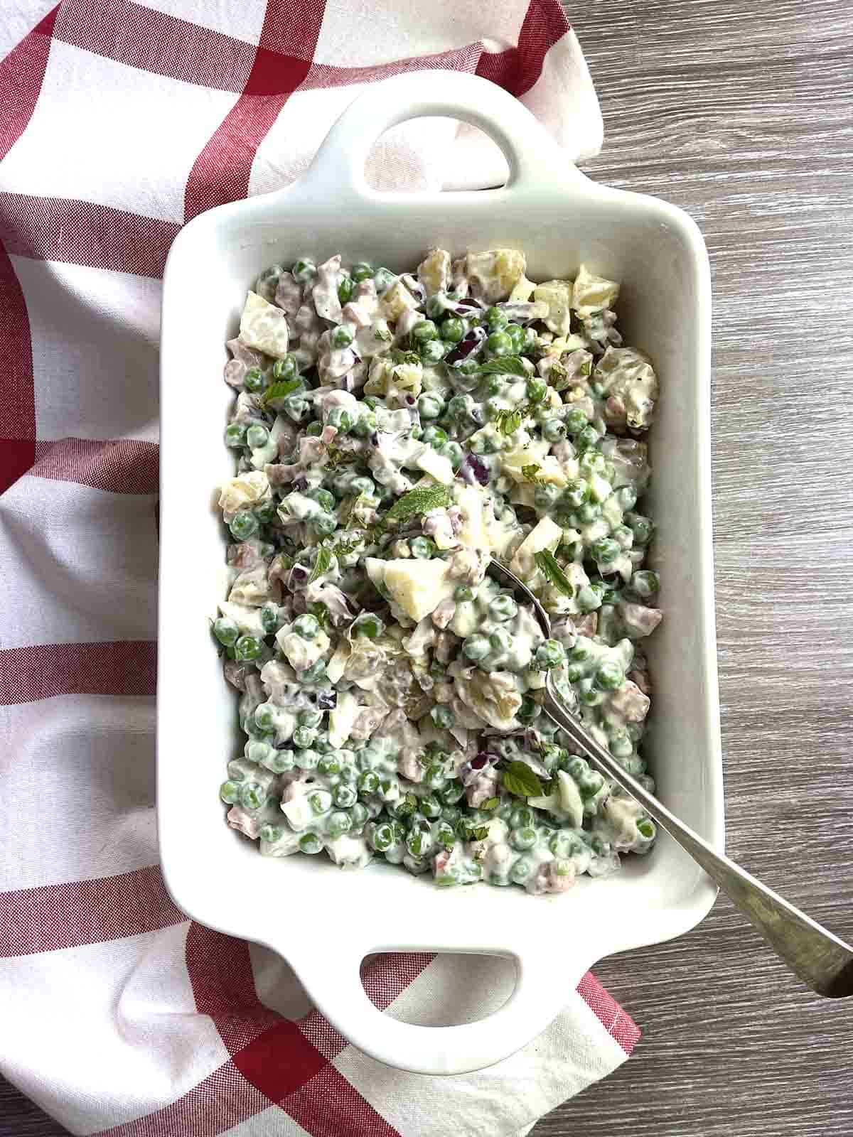 English pea salad in a white dish.